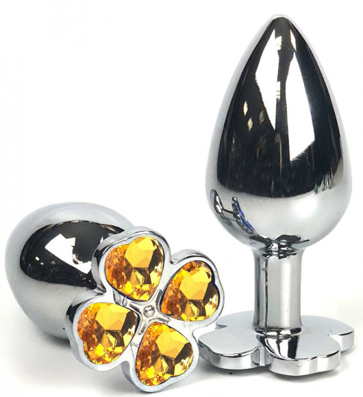 Серебристая анальная втулка с клевером из оранжевых кристаллов - 9 см. Серебристая анальная втулка с клевером из оранжевых кристаллов - 9 см.